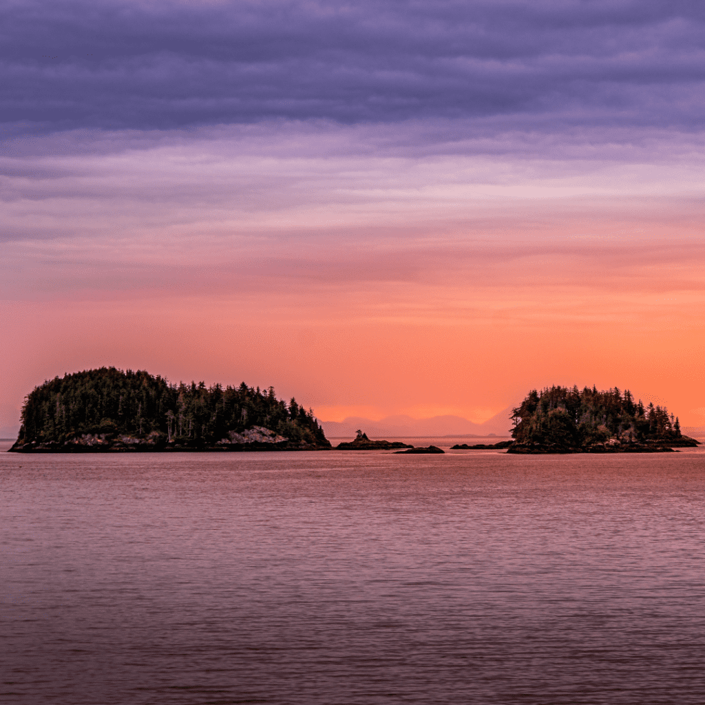 The sun rising over small island as seen from the Prince Rupert to Port Hardy Ferry.