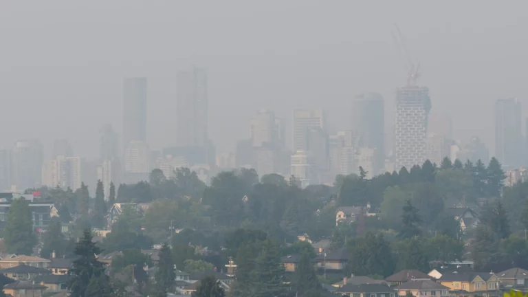 A landscape picture of a Canadian city covered in smoke from the seasonal wildfire